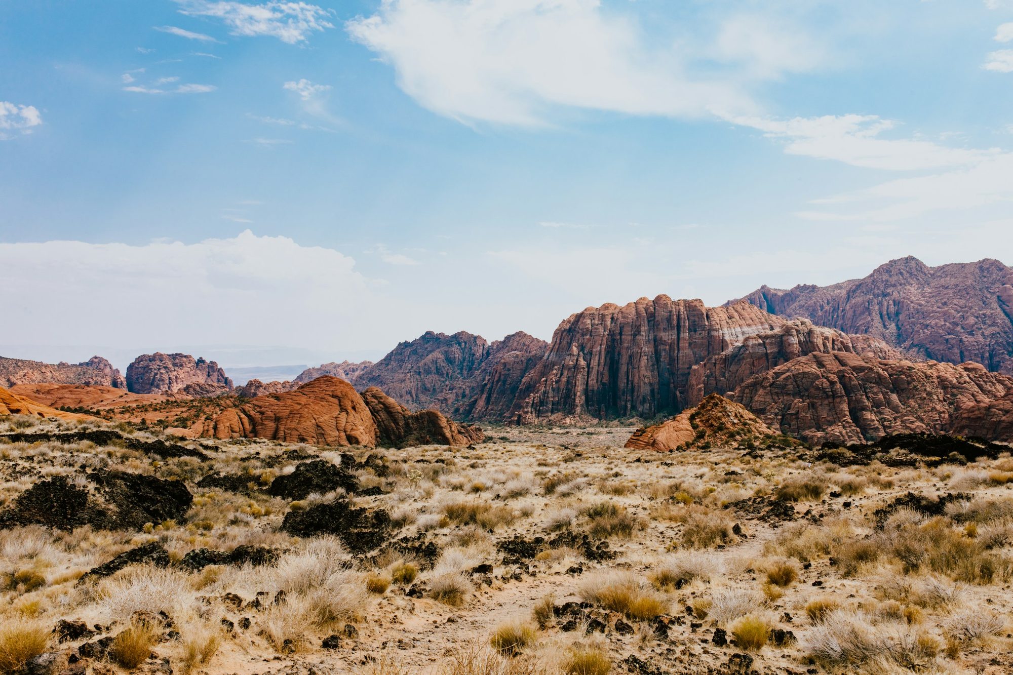 Red and white sandstone cliffs rising over the desert in Snow Canyon near St. George, Utah